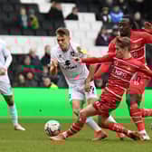 Scott Twine gets tackled by Doncaster’s Ethan Galbraith as Dons drew a blank on Saturday