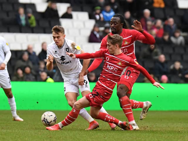 Scott Twine gets tackled by Doncaster’s Ethan Galbraith as Dons drew a blank on Saturday
