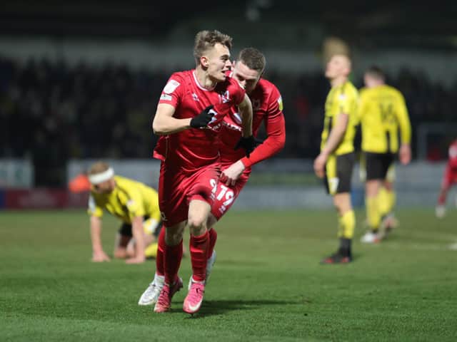 <p>Scott Twine wheels away in celebration after scoring his 95th minute winner against Burton Albion</p>
