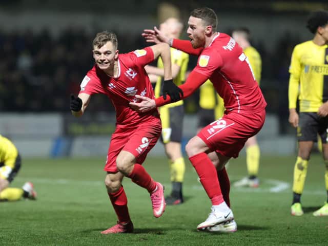 <p>Scott Twine celebrates his stoppage time winner with Connor Wickham against Burton Albion</p>