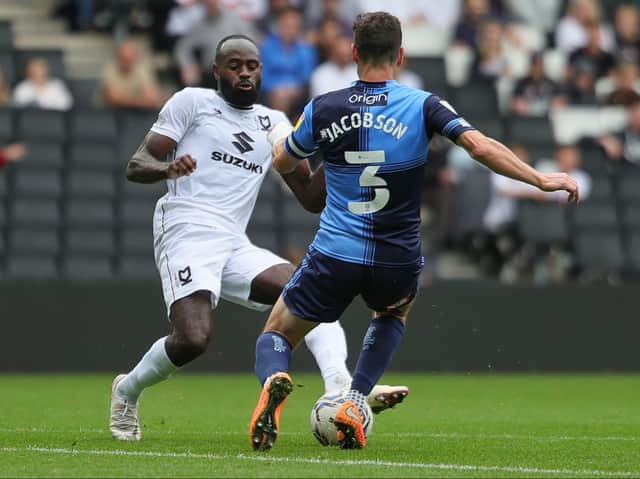 <p>Hiram Boateng and Joe Jacobson fly into a challenge when Dons and Wycombe met back in September</p>