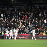 The Dons players urging the travelling fans to stop the abusive chanting
