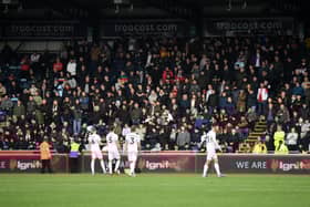 The Dons players urging the travelling fans to stop the abusive chanting