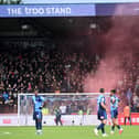 A smoke grenade was set off in the MK Dons end of supporters after Scott Twine scored at Adams Park on Saturday