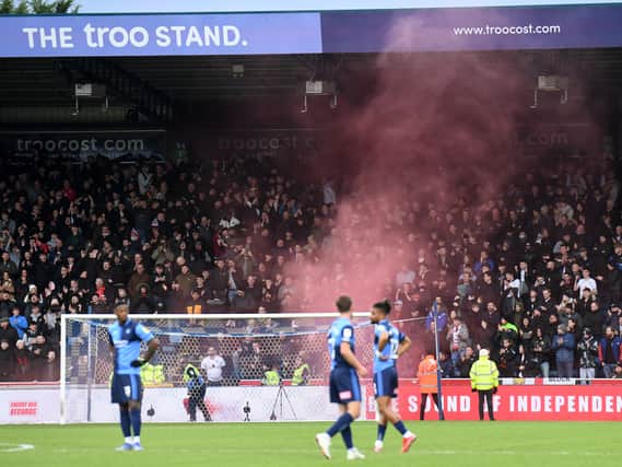 A smoke grenade was set off in the MK Dons end of supporters after Scott Twine scored at Adams Park on Saturday