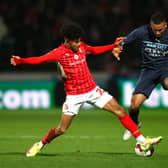 Kaine Kesler tackles Manchester City’s Gabriel Jesus during his loan spell at Swindon Town. 