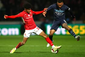 Kaine Kesler tackles Manchester City’s Gabriel Jesus during his loan spell at Swindon Town. 