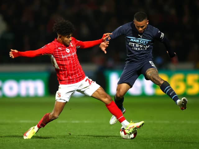 Kaine Kesler tackles Manchester City’s Gabriel Jesus during his loan spell at Swindon Town. 