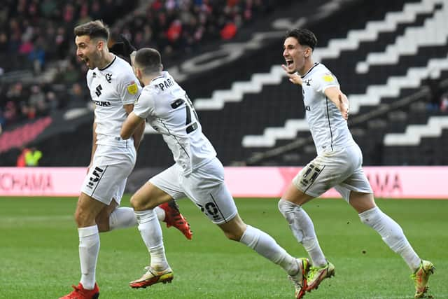 Warren O’Hora is joined by Troy Parrott and Theo Corbeanu as they celebrate his first goal of the season