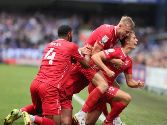<p>MK Dons celebrate Scott Twine’s brilliant free-kick during the 2-2 draw with Ipswich Town at Portman Road earlier this season</p>
