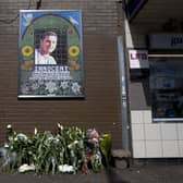 Flowers are left by a mosaic dedicated to Brazilian Jean Charles de Menezes outside Stockwell Underground Station on the tenth anniversary of his death in London on July 22 2015.