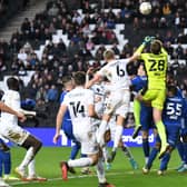 Harry Darling goes up to challenge with Ipswich keeper Christian Walton