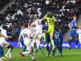 Harry Darling goes up to challenge with Ipswich keeper Christian Walton