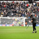 MK Dons ground staff tend to the pitch before the game with Ipswich on Saturday