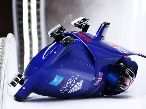  Brad Hall and Nick Gleeson of Team Great Britain crash during the 2-man Bobsleigh Heat 3 on day 11 of Beijing 2022 Winter Olympic Games