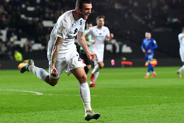 Troy Parrott shows just how much his goal meant to him as he opened the scoring against Cheltenham on Tuesday. Mo Eisa netted Dons’ second two minutes later before Parrott added his second and Dons’ third late on.