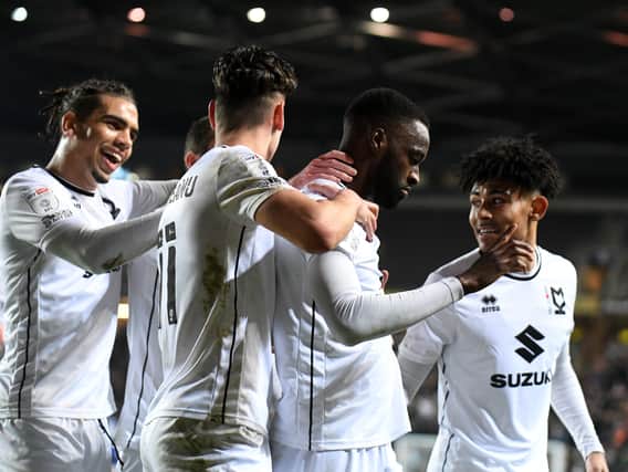 MK Dons celebrate Mo Eisa’s fourth goal in as many starts on Tuesday night against Cheltenham Town