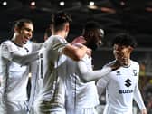 MK Dons celebrate Mo Eisa’s fourth goal in as many starts on Tuesday night against Cheltenham Town