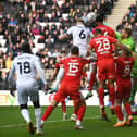 Harry Darling reaches Scott Twine’s corner to head Dons level against Wigan Athletic on Saturday - his eighth goal of the season from a corner.