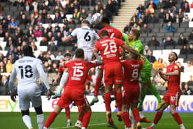 Harry Darling reaches Scott Twine’s corner to head Dons level against Wigan Athletic on Saturday - his eighth goal of the season from a corner.