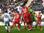 Harry Darling reaches Scott Twine’s corner to head Dons level against Wigan Athletic on Saturday - his eighth goal of the season from a corner.