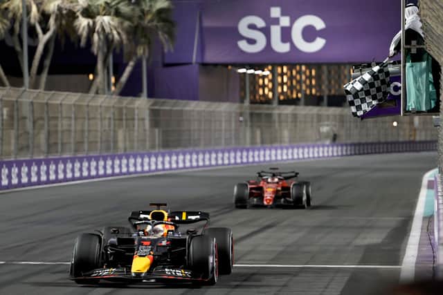 Max Verstappen crosses the line just ahead of Charles Leclerc to claim his first win of the season