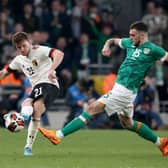 Troy Parrott vies with Belgium’s Thomas Foket during their friendly on Saturday night