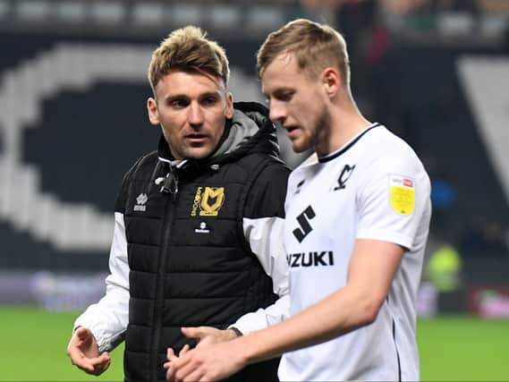 Chris Hogg and Harry Darling in discussion after a game. Hogg was deemed the mastermind behind Dons’ newfound potency from set-pieces but he insists it’s the players who should take the praise
