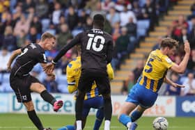 Scott Twine sees his shot blocked by Shrewsbury. Chris Hogg said Dons have gone back to the game at Montgomery Waters Meadow on several occasions to learn lessons this season.