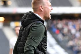 Liam Manning barks his orders from the touchline. He insists a ‘game-by-game’ approach will be best for MK Dons in the final seven matches of the season 