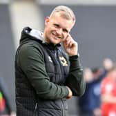 Liam Manning on the sidelines for MK Dons. He praised his squad for producing the goods since the turn of the year after a hectic transfer window