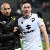 Conor Coventry gets a hug from MK Dons coach David Wright at Stadium MK. Coventry, on loan from West Ham, said the two halves of his season could not be more different after struggling for game time at Peterborough earlier this term.