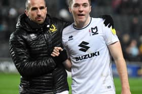 Conor Coventry gets a hug from MK Dons coach David Wright at Stadium MK. Coventry, on loan from West Ham, said the two halves of his season could not be more different after struggling for game time at Peterborough earlier this term.