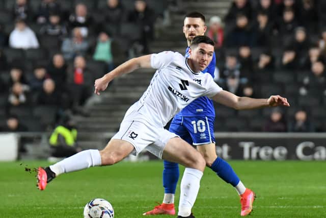 Conor Coventry in action for MK Dons against Cheltenham Town