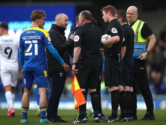 Mark Bowen remonstrates with referee James Oldham at full-time. The AFC Wimbledon boss said he felt for the home fans after his side came within 10 minutes of ending their winless streak which dates back to December 7, 2021