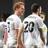 Dean Lewington and Troy Parrott celebrate the Irishman’s second goal against Cheltenham Town. The Dons skipper said he has a good working relationship with the on loan Spurs man