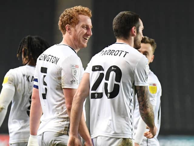 <p>Dean Lewington and Troy Parrott celebrate the Irishman’s second goal against Cheltenham Town. The Dons skipper said he has a good working relationship with the on loan Spurs man</p>