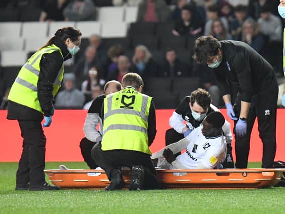 Mo Eisa is helped onto the stretcher after suffering an injury against Sheffield Wednesday. Dons went 3-0 inside the opening half hour at Stadium MK, but fought back to 3-2 - a defeat which ended their 15-game unbeaten run