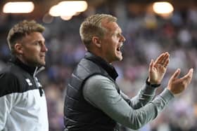 Liam Manning applauds his side from the dugout against Sheffield Wednesday. Although his side’s unbeaten run came to an end at 15 games on Saturday, he said he can already see the bigger picture