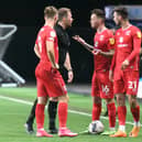 Josh McEachran leads the discussions with referee Anthony Backhouse during the 1-0 defeat to Oxford United. The former Chelsea midfielder said the first half at the Kassam Stadium was one of Dons’ best performances of the season.