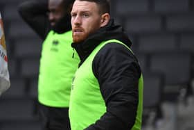 Striker Connor Wickham will face a late fitness test on Friday after missing Tuesday’s game with Oxford. His absence, and Mo Eisa’s long-term injury, leave Dons short on numbers up front.