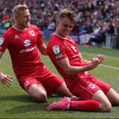 Scott Twine celebrates with fellow goal-scorer Harry Darling during the win over Plymouth Argyle. Twine netted four goals at Home Park to take his tally to 20 for the season.