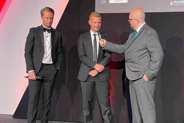 Liam Manning is interviewed by Dean Bowditch (L) and Luke Ashmead (R) at the MK Dons Player of the Year Awards