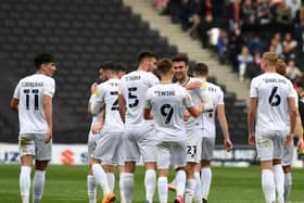 MK Dons celebrate Daniel Harvie’s goal against Morecambe. Although they missed out on automatic promotion, going up via the play-offs is still a possibility.