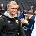 MK Dons head coach Liam Manning said he is fully focused on the play-off campaign against Wycombe Wanderers. He has however been linked with the manager’s job at Queens Park Rangers this week.