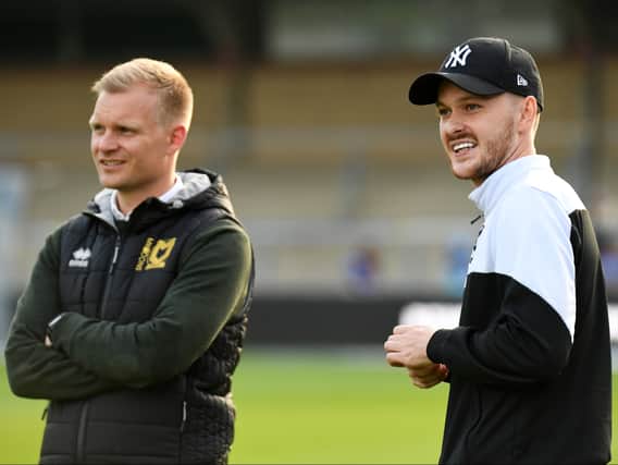 Liam Manning with Josh McEachran before the first-leg of the play-offs on Thursday night. Though McEachran is suspended for the second-leg, Manning said the 29-year-old will play a part in Dons’ preparations