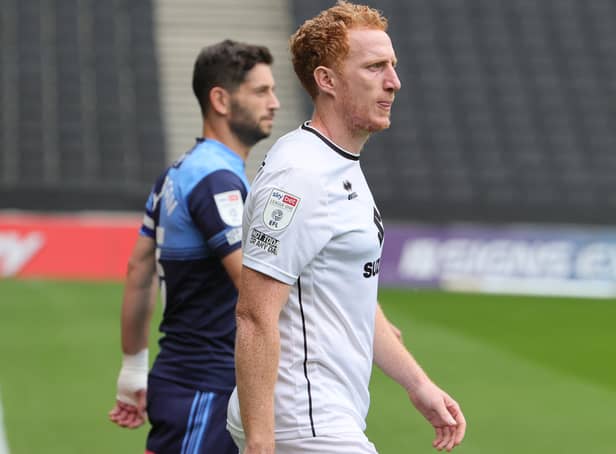 <p>Dean Lewington strides out at Stadium MK alongside Wycombe captain Joe Jacobson earlier this season. The clash tomorrow, according to Lewington, is one of the biggest games in Dons’ history.</p>