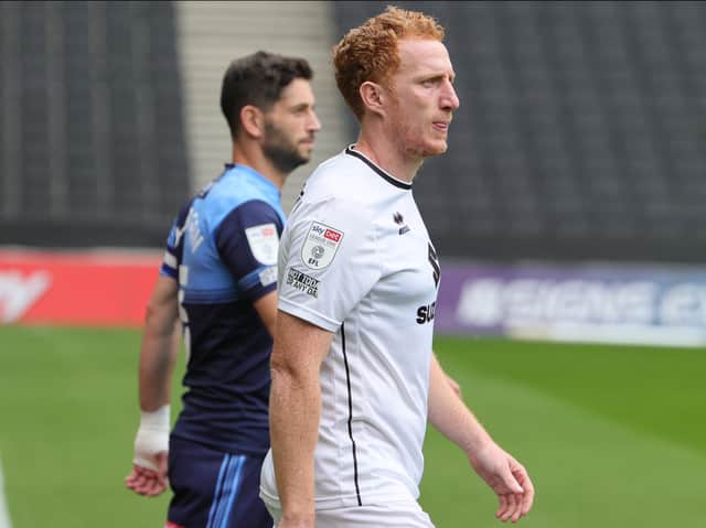 <p>Dean Lewington strides out at Stadium MK alongside Wycombe captain Joe Jacobson earlier this season. The clash tomorrow, according to Lewington, is one of the biggest games in Dons’ history.</p>