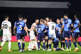 Tempers flared when the sides met on Thursday at Adams Park. Both Liam Manning and Dean Lewington believe more pressure will be on Wycombe when the sides meet at Stadium MK