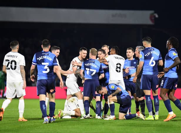 <p>Tempers flared when the sides met on Thursday at Adams Park. Both Liam Manning and Dean Lewington believe more pressure will be on Wycombe when the sides meet at Stadium MK</p>